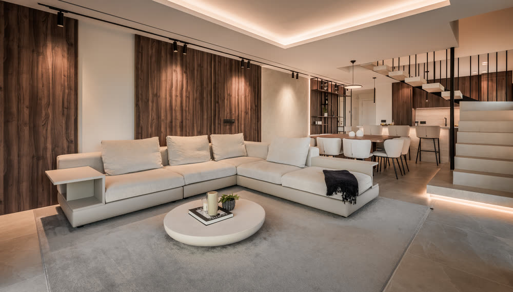Open-plan living room in walnut and stone