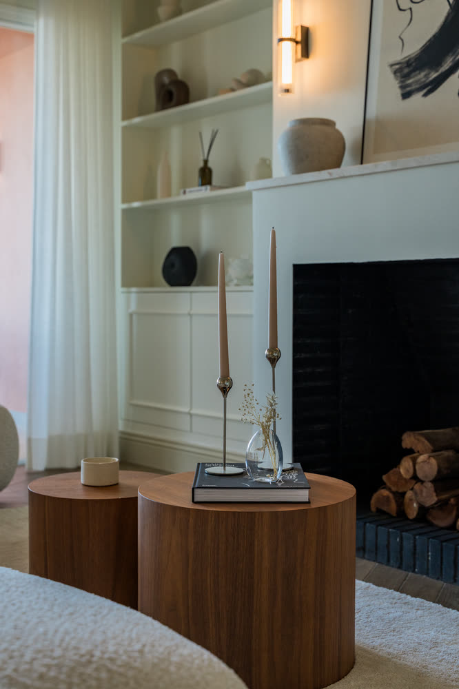 White sitting room with a fireplace and built-in shelving