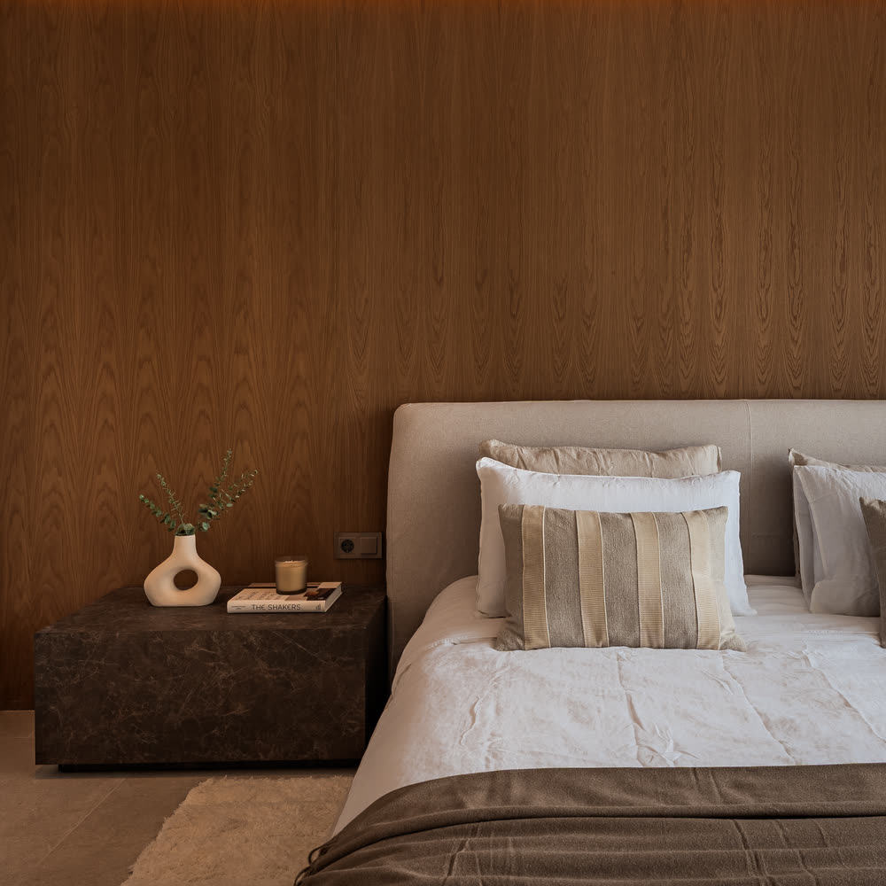 Bedroom with a timber headboard wall and soft linen
