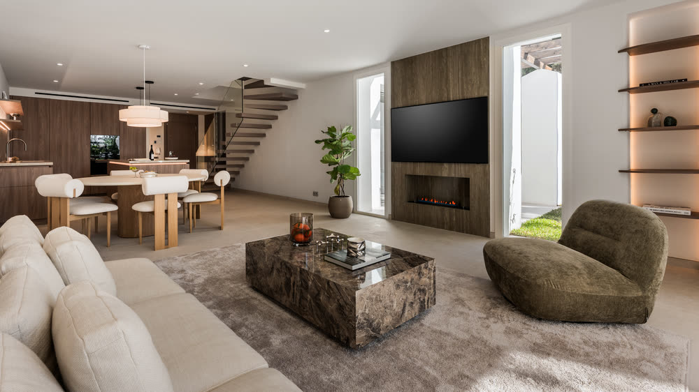Living room with a stone coffee table and green velvet chairs