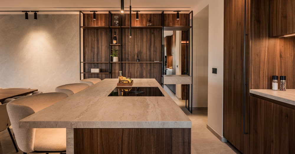 Kitchen with walnut cabinetry and a long stone island