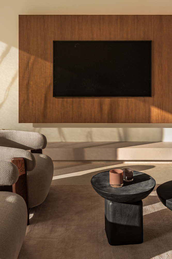 Snug corner with an oak media wall and a round side table
