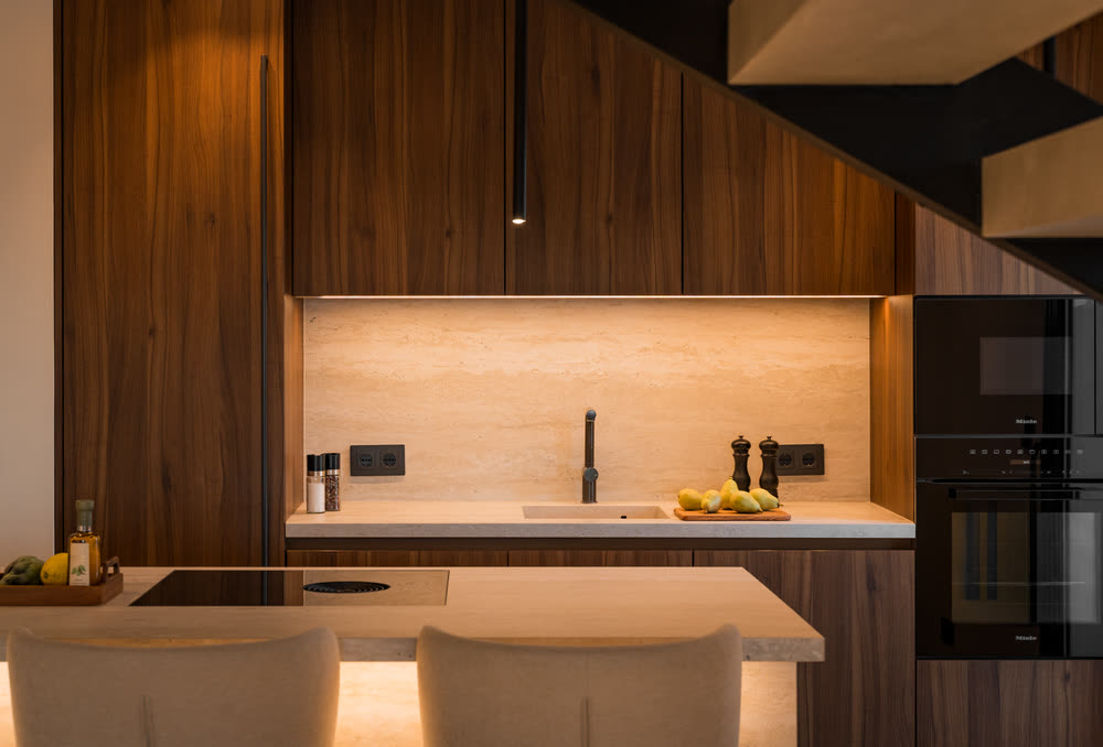 Dark walnut kitchen with warm under-cabinet lighting