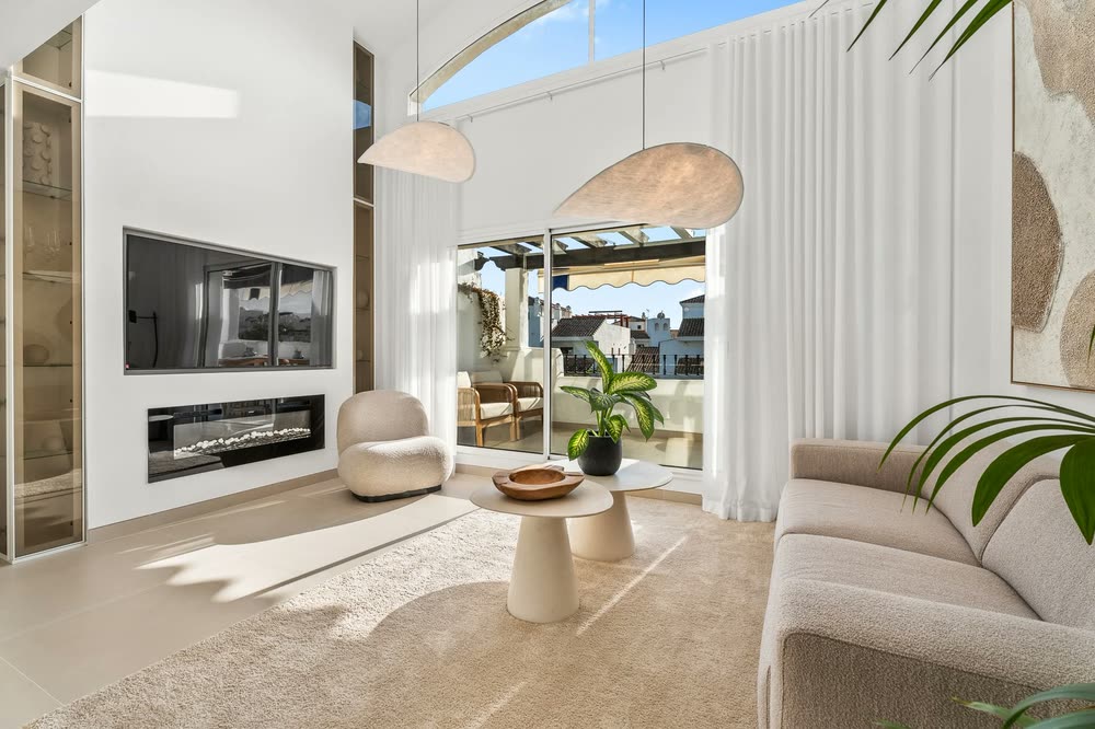 White living room with a linear fireplace and terrace doors